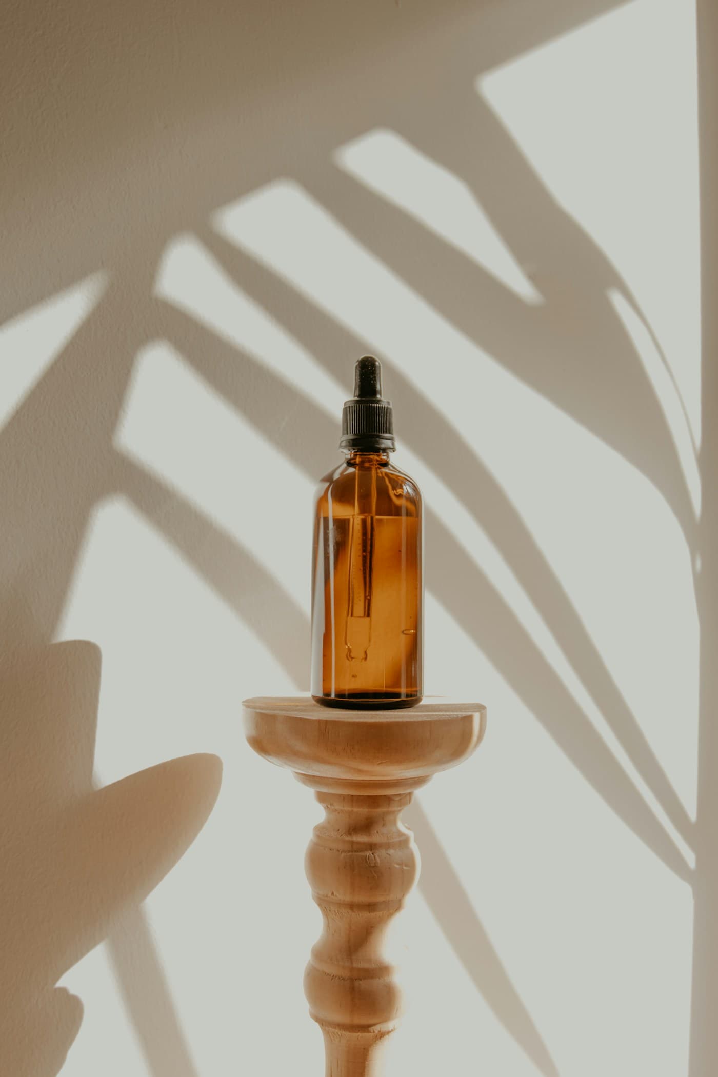 Amber dropper bottle in warm sunlight, shown as handmade gift mood inspiration